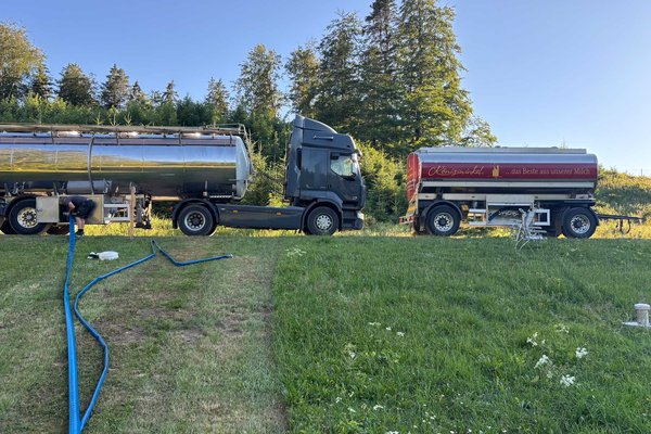 Ansicht Tankwagen pumpt Trinkwasser in die Behälter